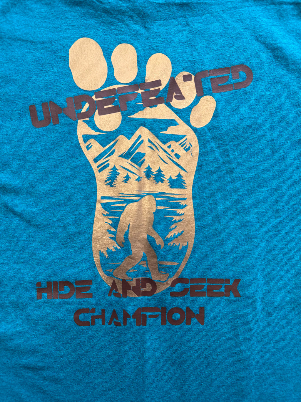 Bigfoot “Believe – Undefeated Hide and Seek Champion” Graphic T-Shirt